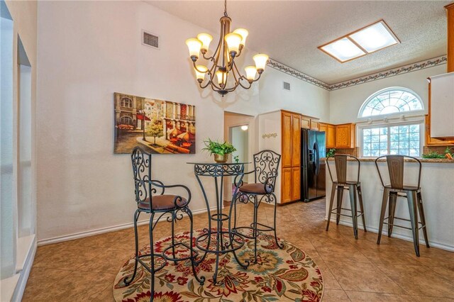 4102 Castle Valley Dr, Corpus Christi, TX 78410 - dining space with a chandelier, a textured ceiling, and light tile patterned floors