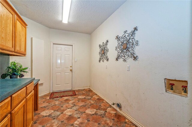 4102 Castle Valley Dr, Corpus Christi, TX 78410 - washroom with cabinet space, a textured ceiling, and hookup for a washing machine