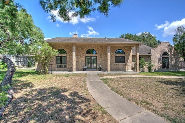 4102 Castle Valley Dr, Corpus Christi, TX 78410 - view of front of house with french doors, brick siding, and a chimney