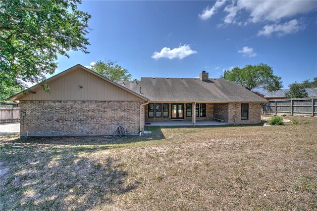 4102 Castle Valley Dr, Corpus Christi, TX 78410 - back of property with brick siding, a chimney, and a patio area