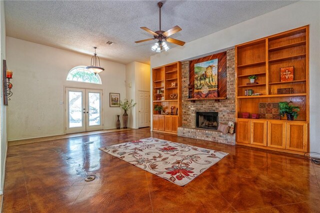 4102 Castle Valley Dr, Corpus Christi, TX 78410 - living room featuring a textured ceiling, french doors, built in features, a brick fireplace, and a ceiling fan