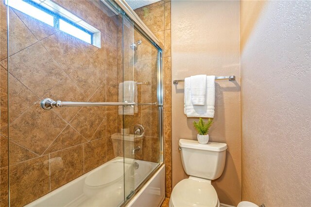 4102 Castle Valley Dr, Corpus Christi, TX 78410 - full bathroom featuring a textured wall, toilet, and enclosed tub / shower combo