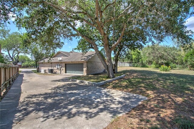 4102 Castle Valley Dr, Corpus Christi, TX 78410 - view of front facade featuring brick siding, an attached garage, and driveway