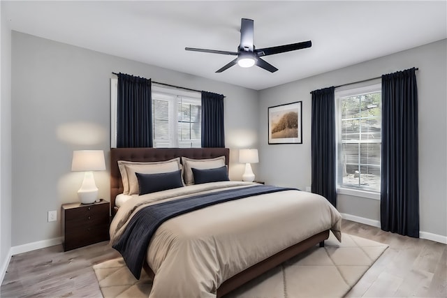 bedroom with ceiling fan and light hardwood / wood-style floors