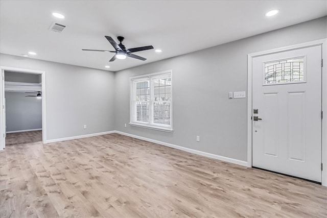 foyer entrance with ceiling fan and light hardwood / wood-style floors