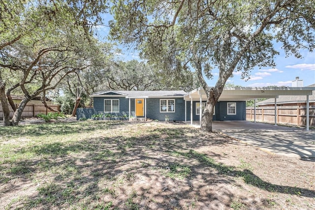 ranch-style house featuring a carport