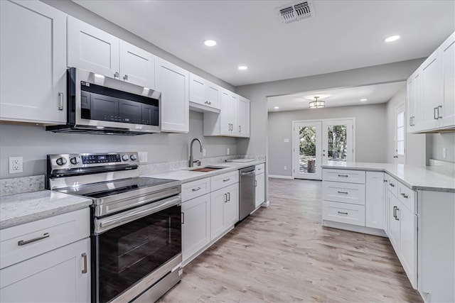 kitchen with white cabinets, stainless steel appliances, and sink