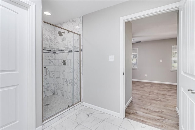 bathroom featuring hardwood / wood-style flooring and a shower with door