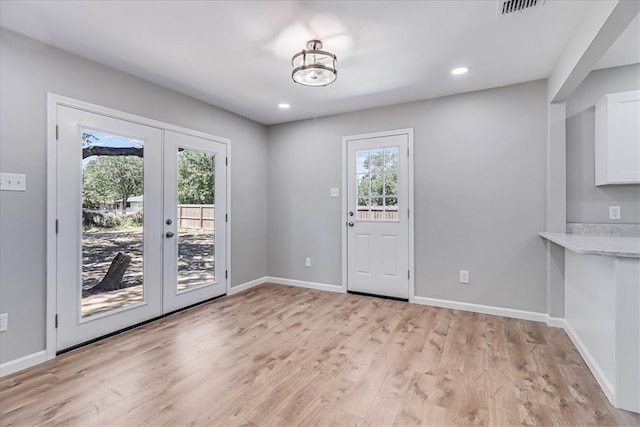 doorway with light hardwood / wood-style flooring and french doors