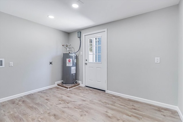 utility room featuring electric water heater