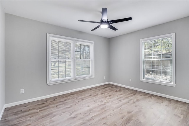 empty room featuring light wood-type flooring and ceiling fan