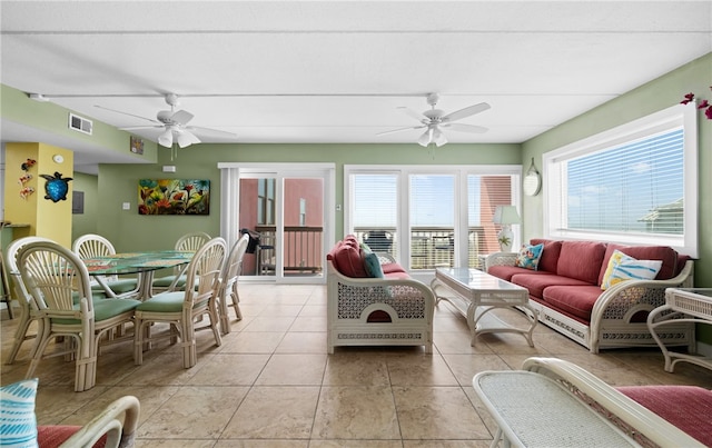 tiled living room featuring ceiling fan