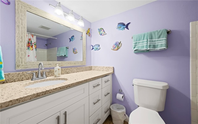 bathroom featuring a shower with curtain, vanity, and toilet