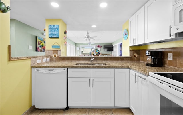 kitchen with tasteful backsplash, sink, white appliances, and white cabinets