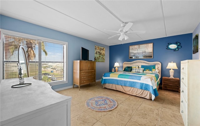 bedroom with ceiling fan and light tile patterned floors