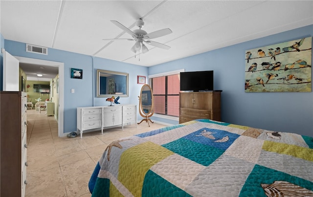 tiled bedroom featuring ceiling fan