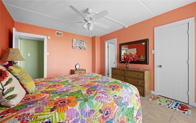 tiled bedroom featuring ceiling fan