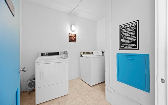 laundry area with light tile patterned flooring and separate washer and dryer