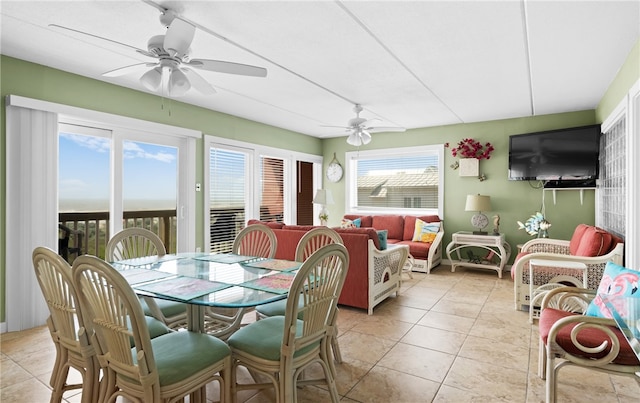 tiled dining space featuring ceiling fan