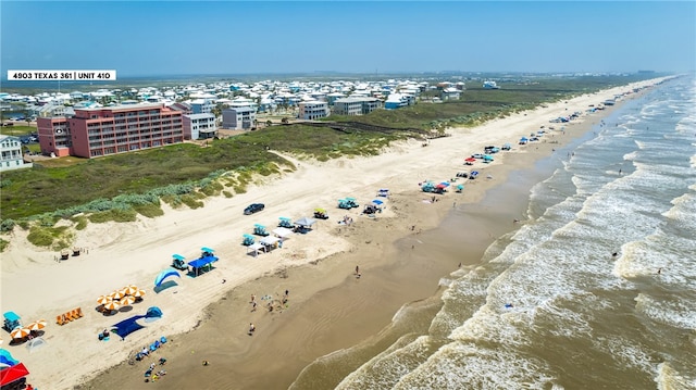 birds eye view of property with a beach view and a water view