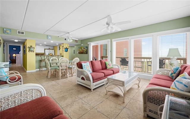 tiled living room with ceiling fan and a healthy amount of sunlight