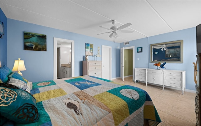 bedroom with light tile patterned floors, ceiling fan, and ensuite bathroom