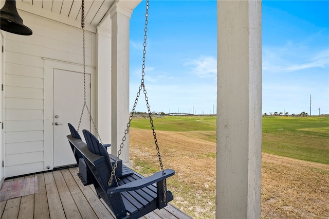 wooden deck featuring a lawn