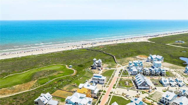 birds eye view of property featuring a water view and a beach view