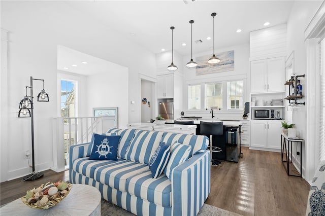 living area with dark wood-style floors, visible vents, and recessed lighting