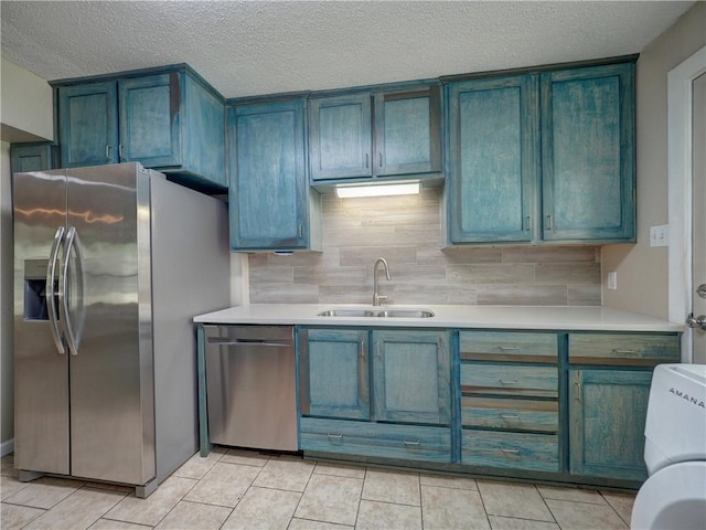2746 Beaumont Ave, Ingleside, TX 78362 - kitchen with a sink, stainless steel appliances, light countertops, decorative backsplash, and a textured ceiling