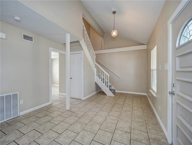2746 Beaumont Ave, Ingleside, TX 78362 - foyer entrance with stairs, light tile patterned floors, lofted ceiling, and baseboards