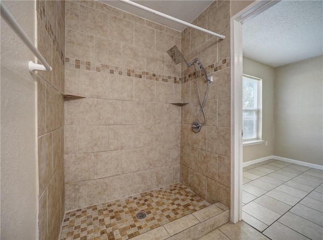 2746 Beaumont Ave, Ingleside, TX 78362 - full bathroom featuring a tile shower, tile patterned floors, a textured ceiling, and baseboards