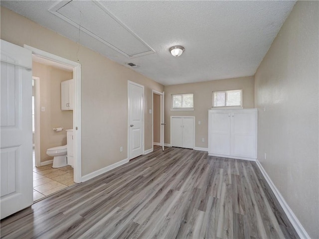 2746 Beaumont Ave, Ingleside, TX 78362 - spare room with attic access, wood finished floors, a textured ceiling, and baseboards