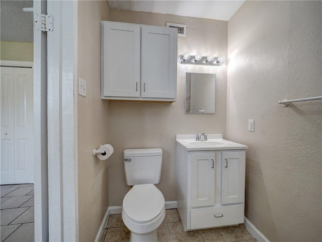 2746 Beaumont Ave, Ingleside, TX 78362 - bathroom featuring tile patterned flooring, toilet, vanity, and baseboards