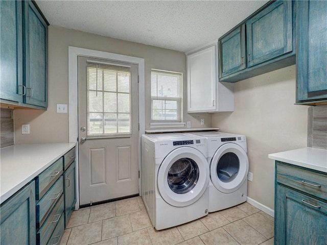 2746 Beaumont Ave, Ingleside, TX 78362 - laundry area with cabinet space, washer and clothes dryer, light tile patterned flooring, a textured ceiling, and baseboards