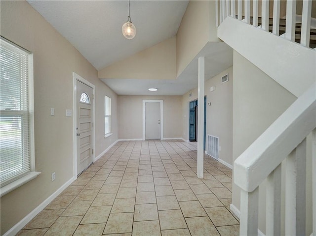 2746 Beaumont Ave, Ingleside, TX 78362 - foyer featuring lofted ceiling, stairway, baseboards, and light tile patterned floors