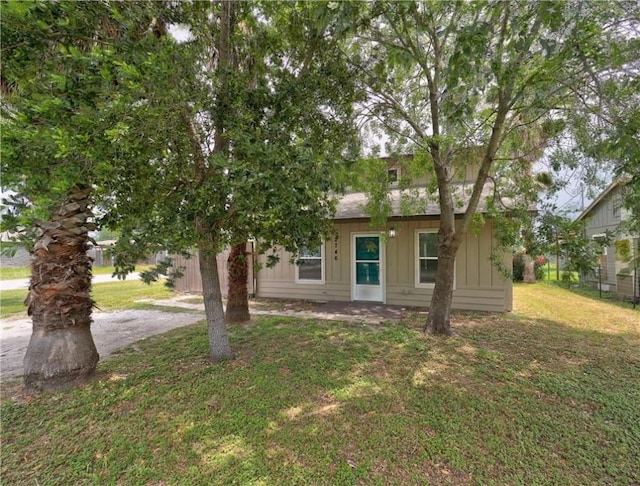 2746 Beaumont Ave, Ingleside, TX 78362 - view of property hidden behind natural elements featuring a front yard and board and batten siding