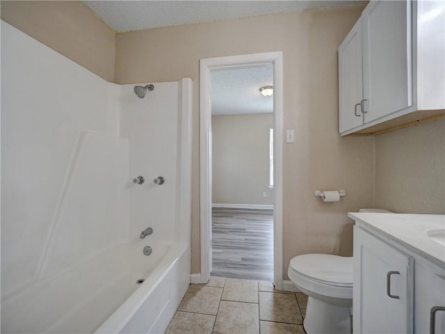 2746 Beaumont Ave, Ingleside, TX 78362 - bathroom with a textured ceiling, toilet, vanity, tile patterned flooring, and  shower combination