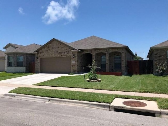 1020 Pasadena St, Portland, TX 78374 - french country home featuring a garage, brick siding, and driveway