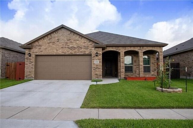 1020 Pasadena St, Portland, TX 78374 - french provincial home featuring brick siding, driveway, a garage, and a shingled roof