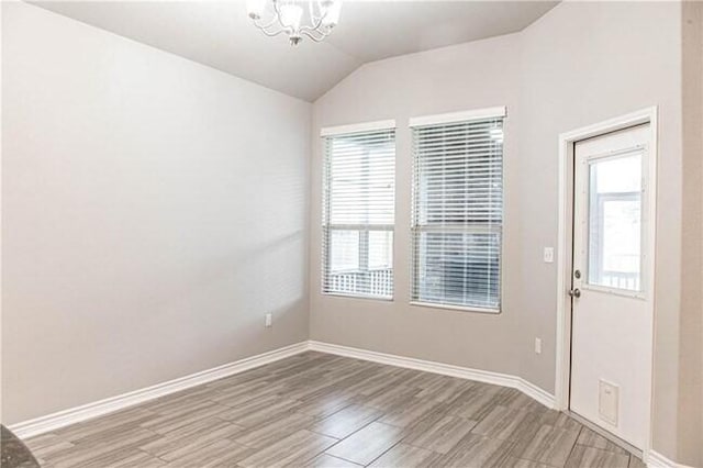 1020 Pasadena St, Portland, TX 78374 - unfurnished dining area with a chandelier, lofted ceiling, light wood-type flooring, and baseboards