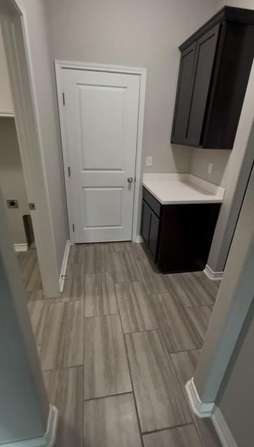 1020 Pasadena St, Portland, TX 78374 - laundry area featuring cabinet space, wood finish floors, and baseboards