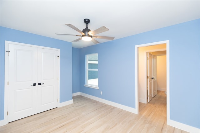 unfurnished bedroom with light hardwood / wood-style flooring, ceiling fan, and a closet