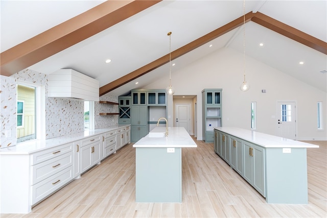 kitchen featuring pendant lighting, a large island, and beam ceiling