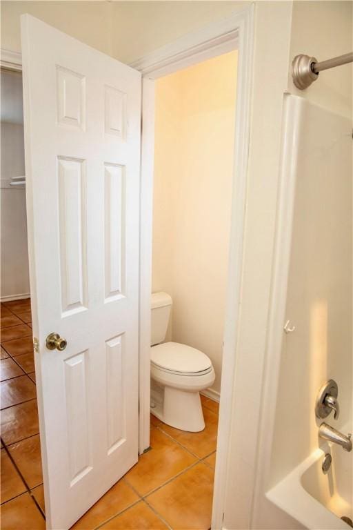 2821 Quebec Dr, Corpus Christi, TX 78414 - bathroom with tile patterned floors, toilet, and bathing tub / shower combination