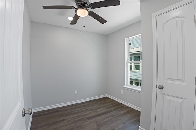 spare room with dark wood-type flooring and ceiling fan