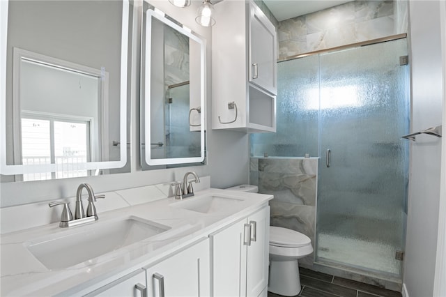 bathroom featuring a shower with shower door, vanity, toilet, and wood-type flooring