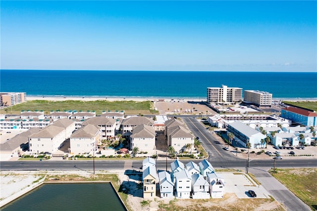 aerial view with a water view and a beach view