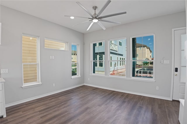 spare room with dark hardwood / wood-style flooring and ceiling fan