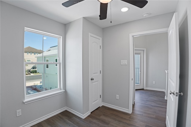 unfurnished bedroom with dark hardwood / wood-style flooring and ceiling fan